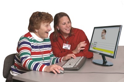 Aphasia, stroke, speech & language therapy. Therapist demonstrating therapy software for speech & language.